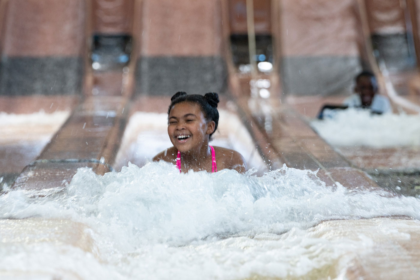 "kid enjoying water slide