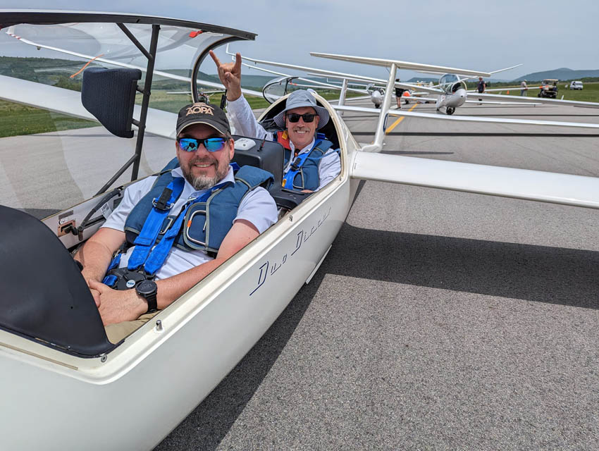 two persons sitting inside glider cabin