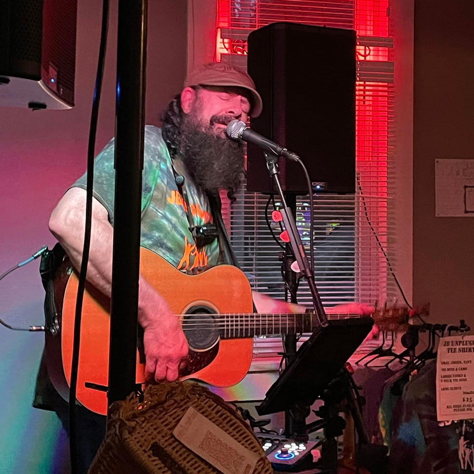 A person playing guitar and singing