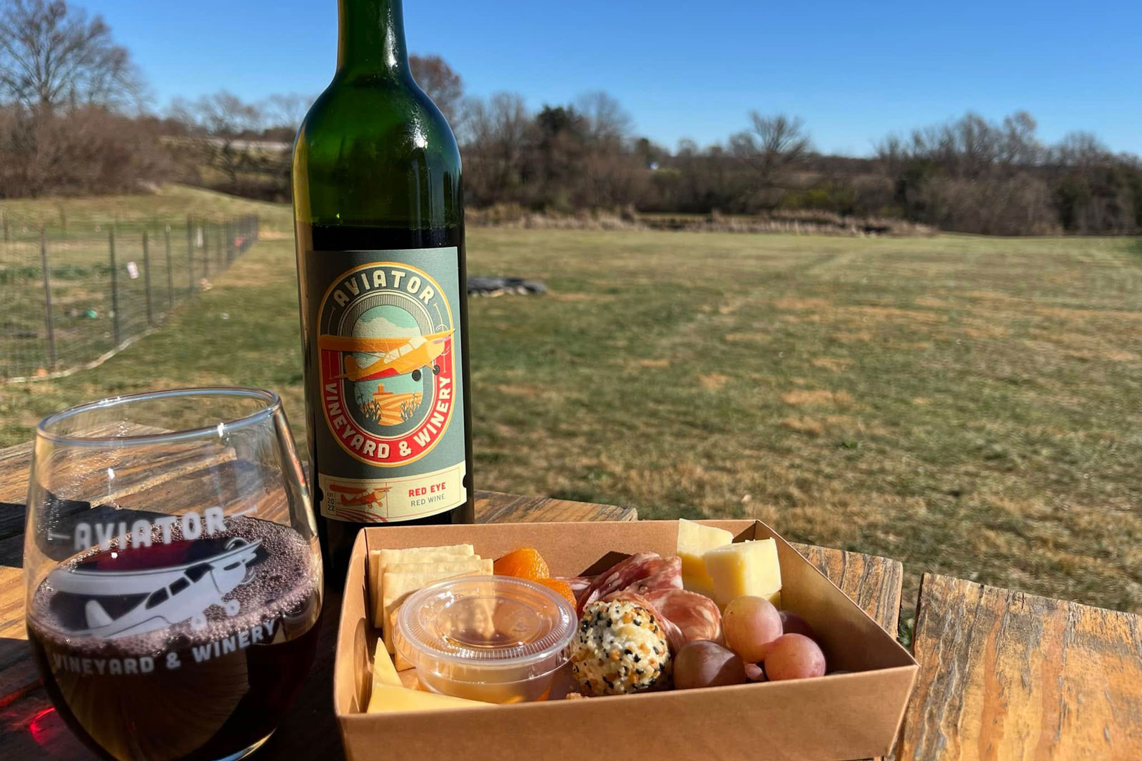 Wine poured in a glass with charcuterie