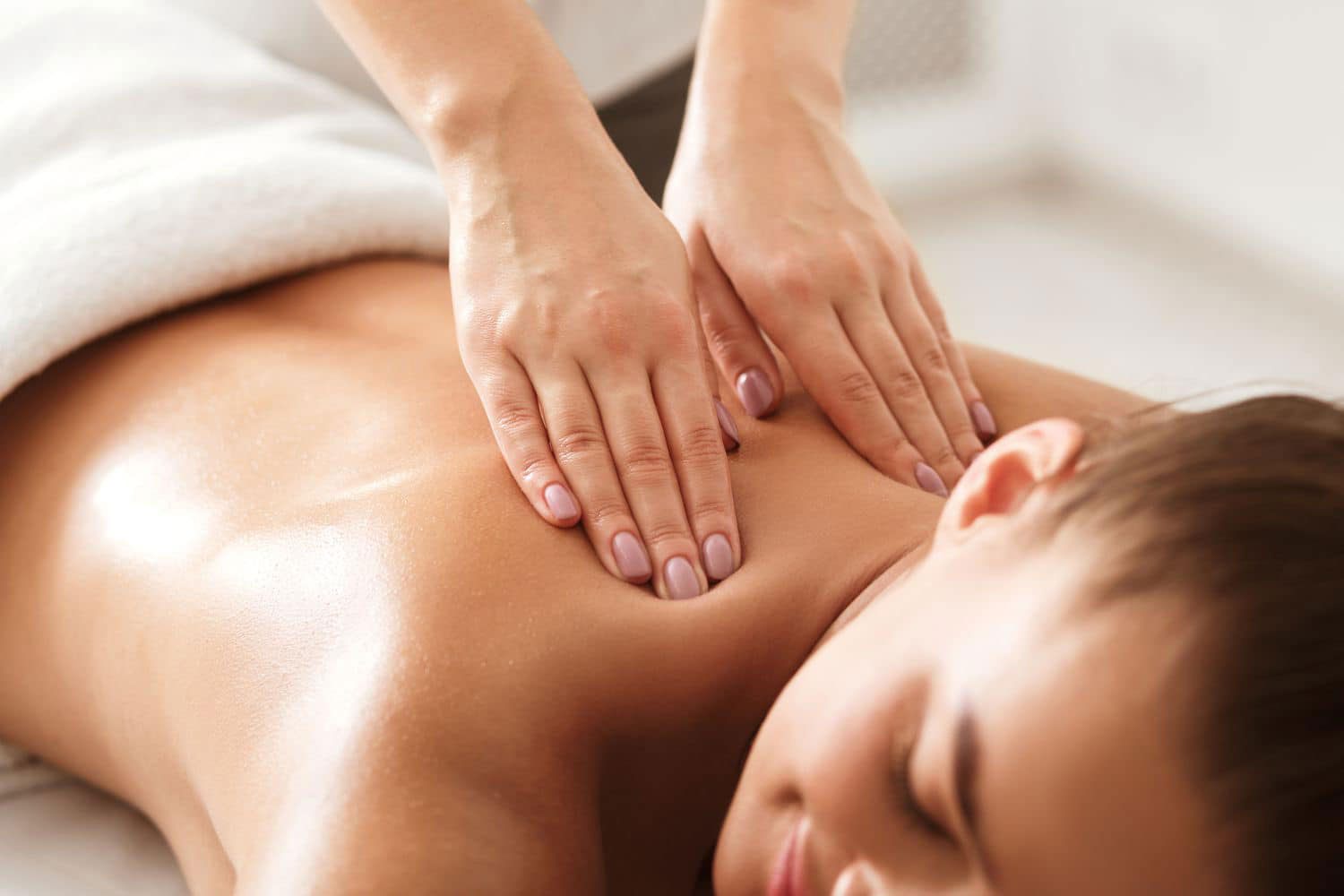 A woman getting body massage at Spa