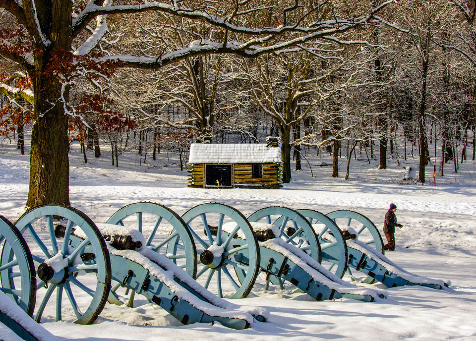 vintage cannons parked in park covered with snow