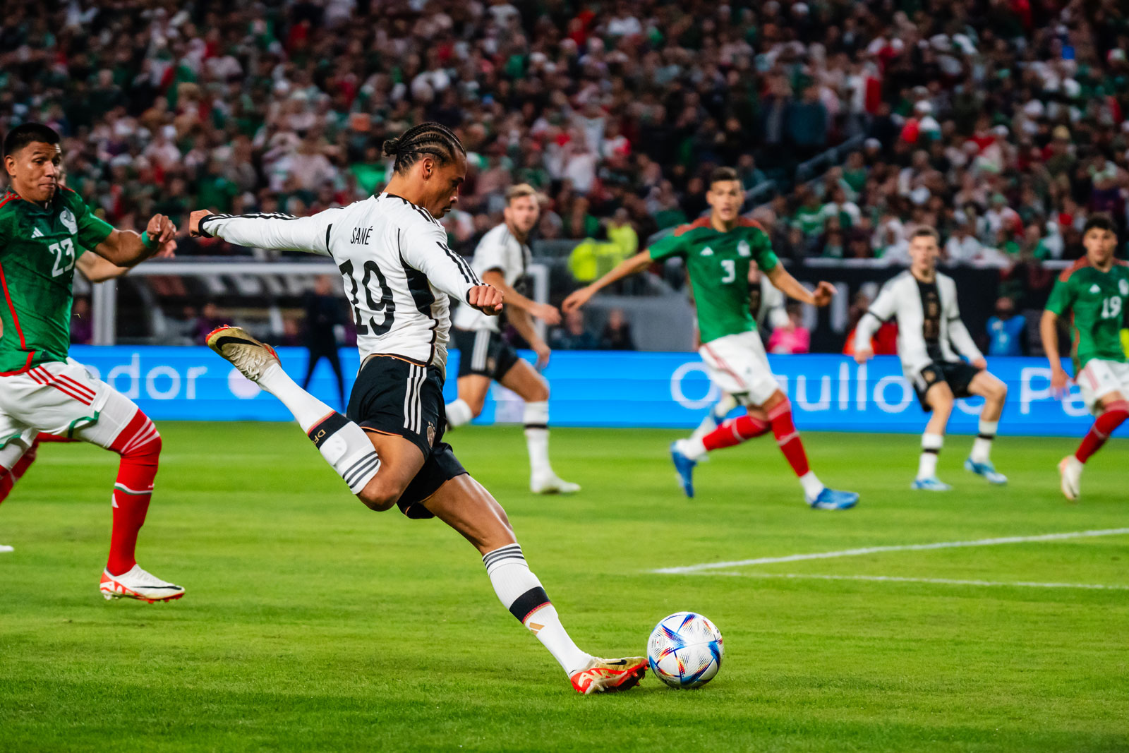 Athletes playing soccer on field