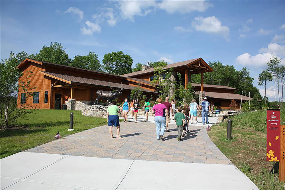 Tourists walking toward Elk Country Visitor Center