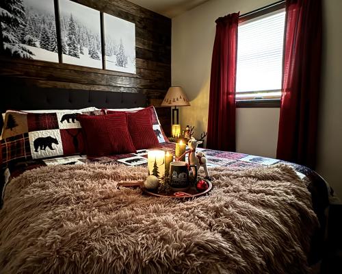 Bed with a candle and goodies at the foot